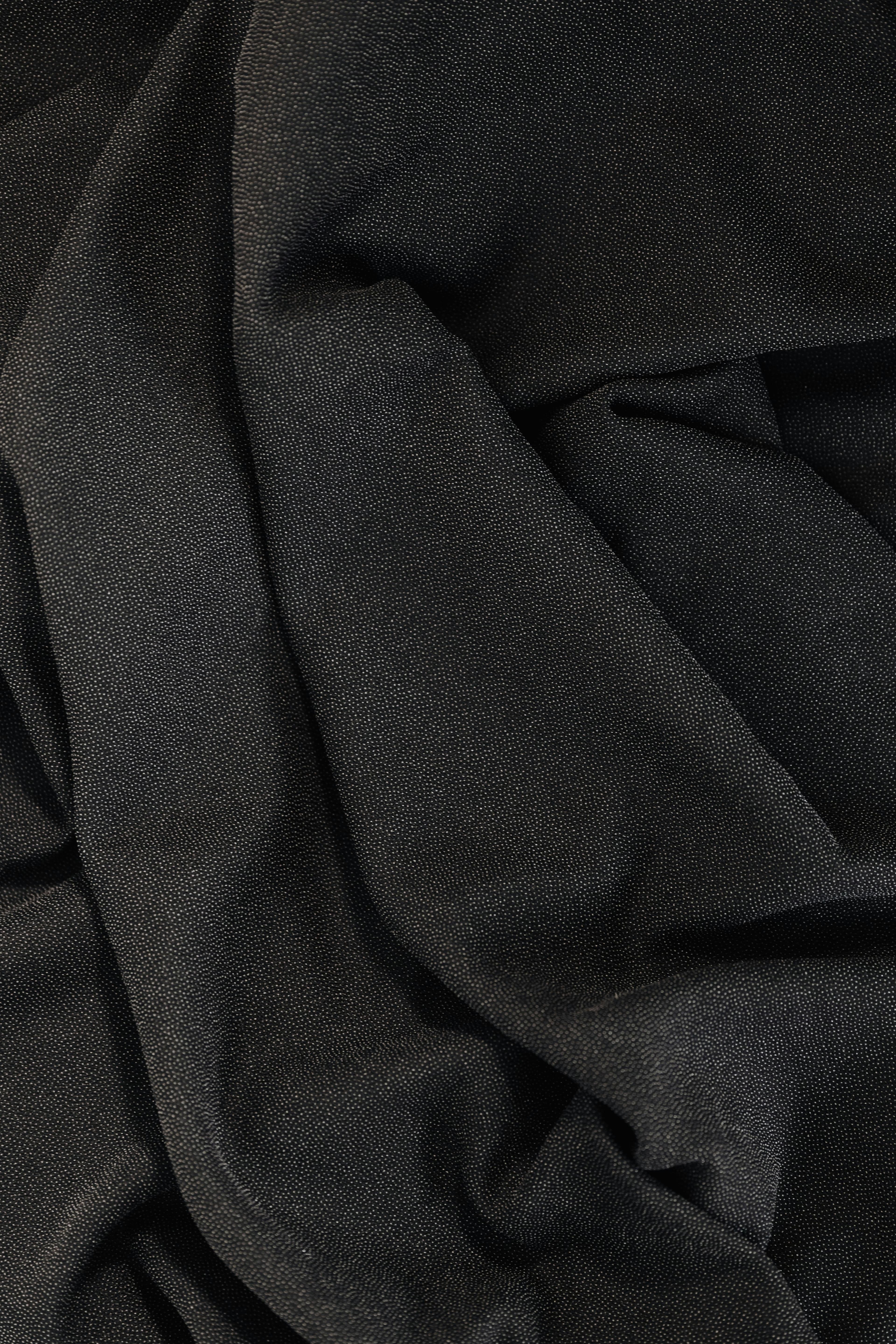 Macro cloth texture representing premium surface material.