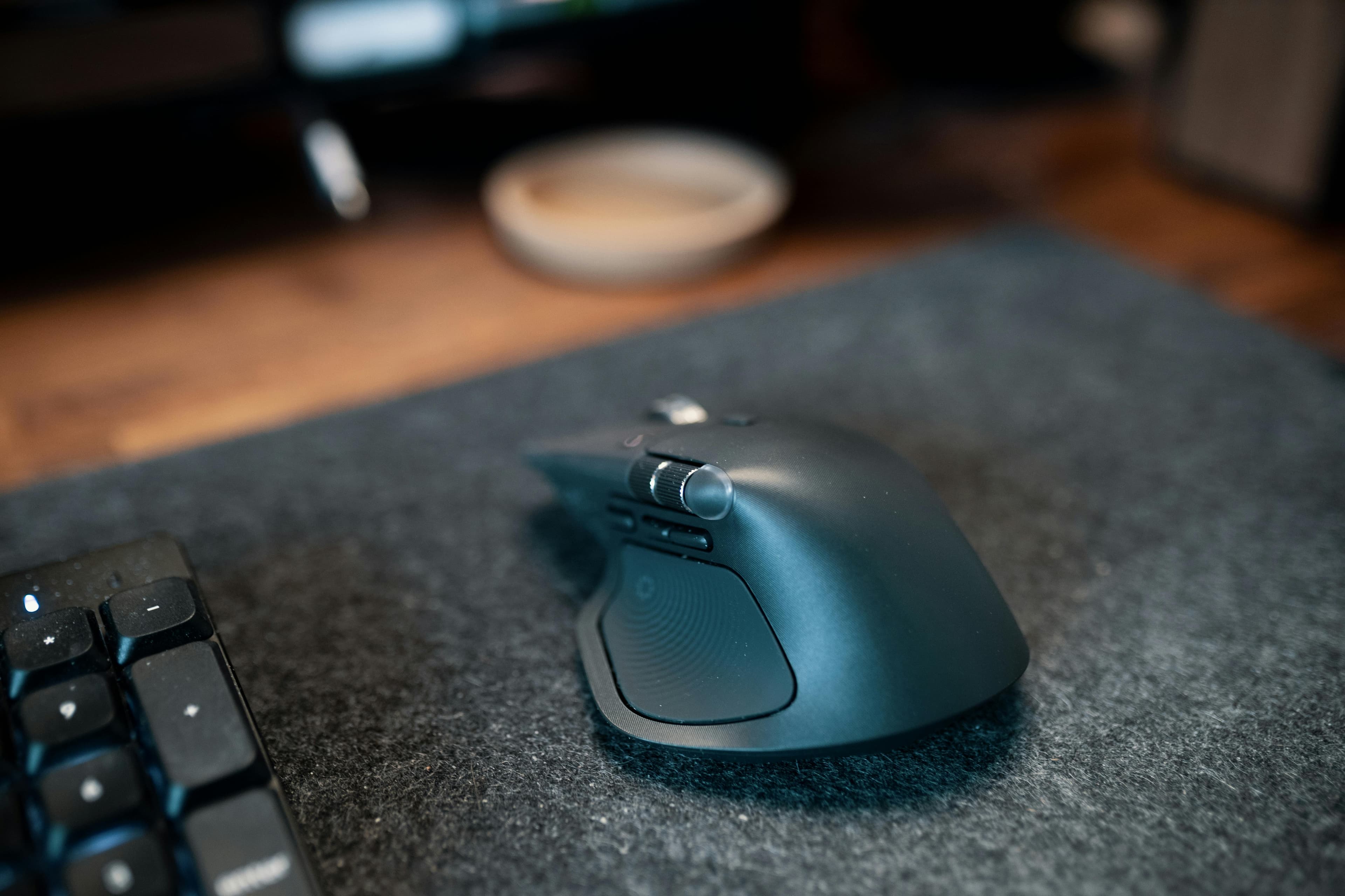 Close-up of a premium mouse on a dark mousepad surface.